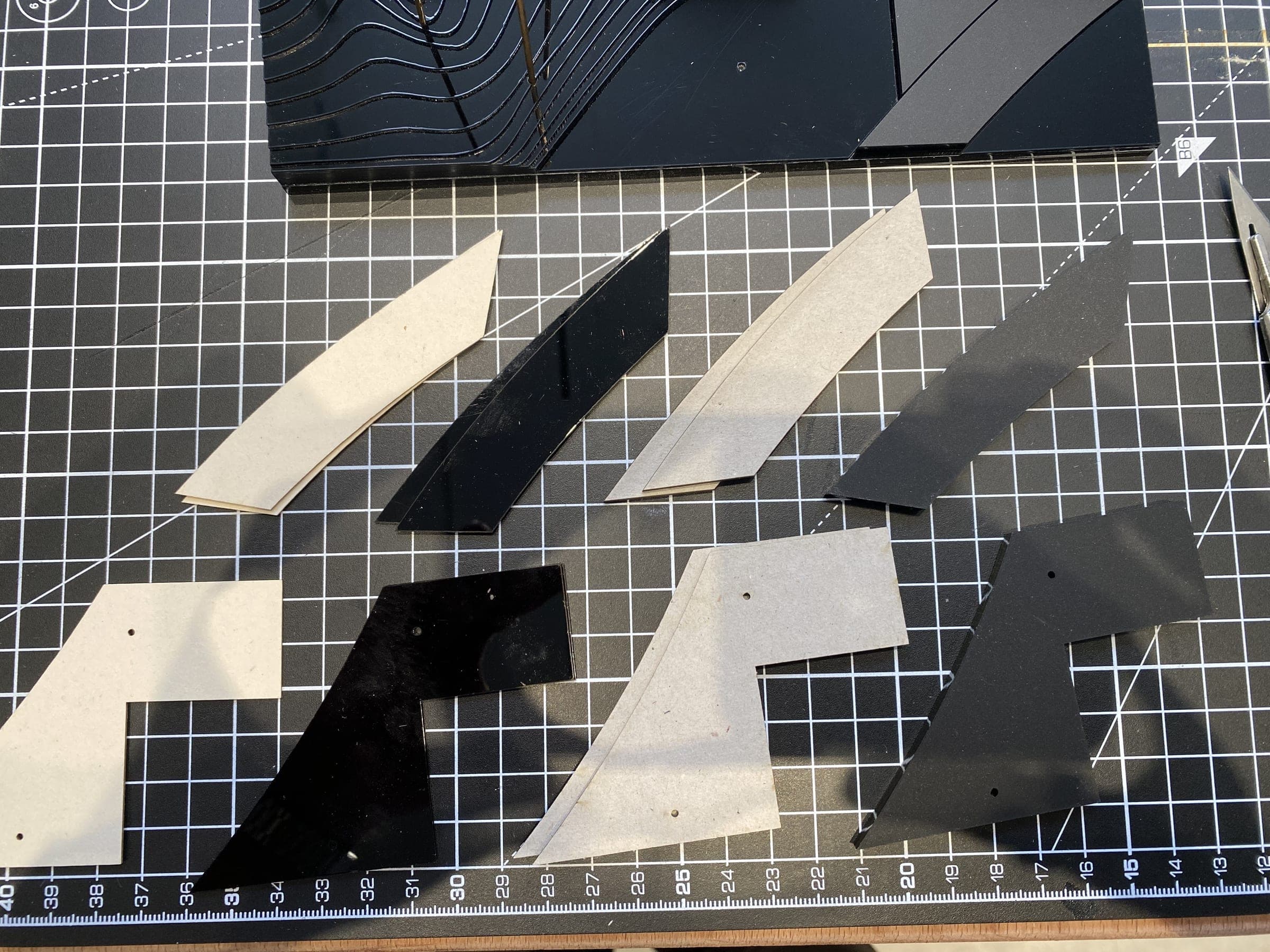 Zaha Hadid — cut acrylic and MDF pieces laid out before assembly