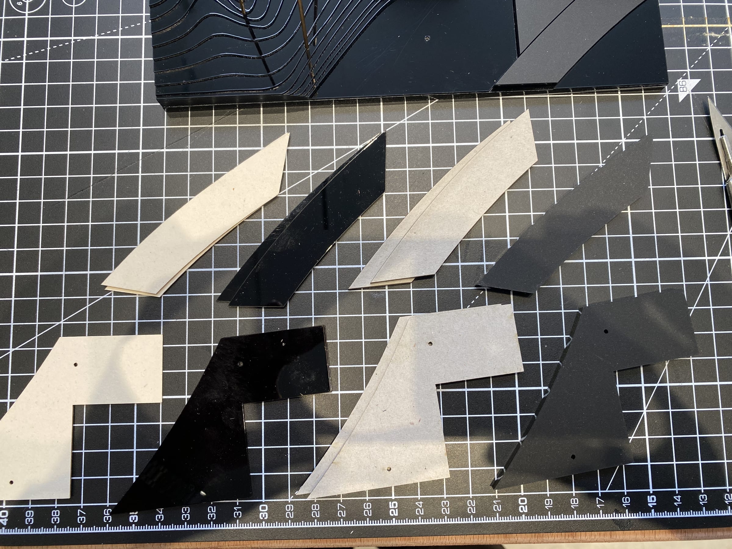 Zaha Hadid — cut acrylic and MDF pieces laid out before assembly